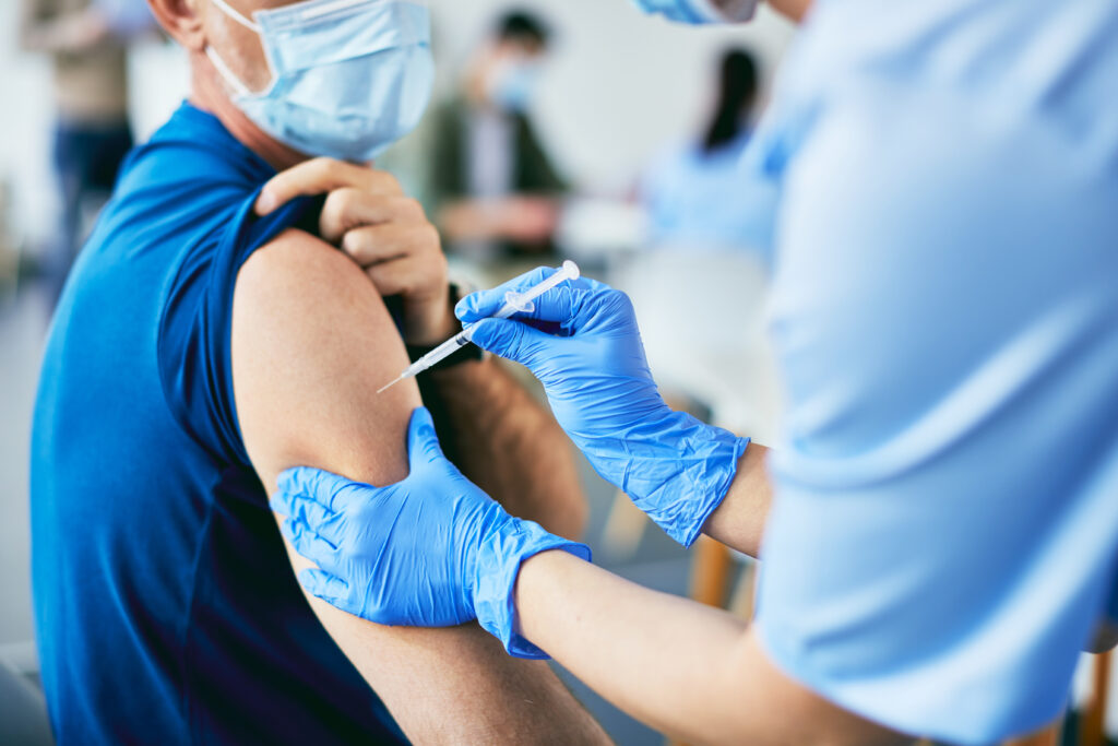 Close-up of man getting a vaccine